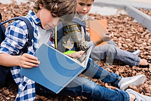 Schoolboys reading books