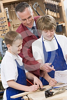 Schoolboys and teacher in woodwork class