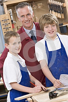 Schoolboys and teacher in woodwork class