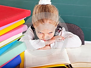 Schoolchild in classroom near blackboard.
