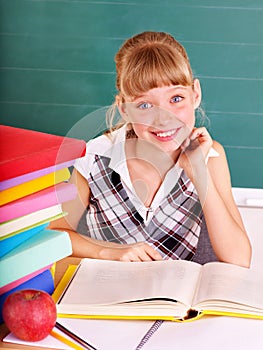 Schoolchild in classroom near blackboard.