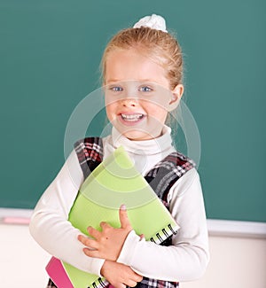 Schoolchild near blackboard. photo