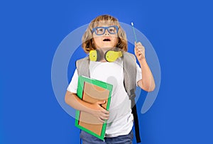 Schoolchild in school uniform with backpack. Teen student on isolated background. Surprised amazed emotions of school