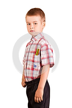 Schoolchild stands, in a shirt pocket pencils, isolated on white