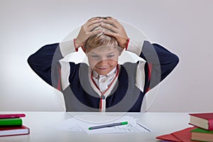 Schoolchild touching his head