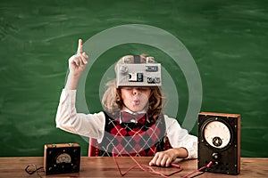 Schoolchild with virtual reality headset in class
