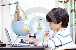 Schoolchild working on a computer photo