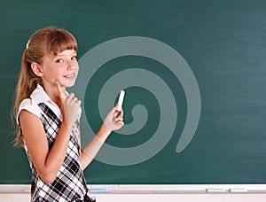 Schoolchild writing on blackboard.