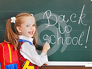 Schoolchild writting on blackboard.