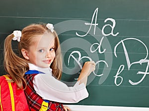 Schoolchild writting on blackboard