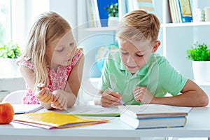 Schoolchildren are came back to school and learning at the table