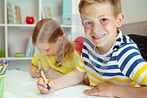 Schoolchildren are came back to school and learning at the table in classroom