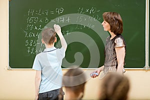 Schoolchildren in classroom at math lesson