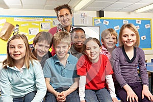 Schoolchildren In classroom with teacher photo