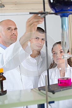 Schoolchildren doing chemistry experiment in science class