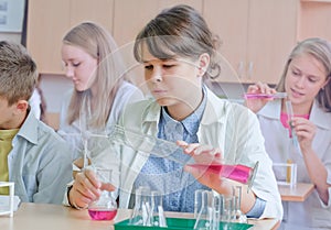 Schoolchildren doing experiment in science class