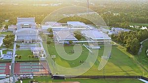 Schoolchildren playing American football game on campus stadium in sports park