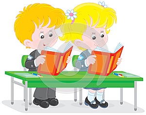 Schoolchildren read at a lesson