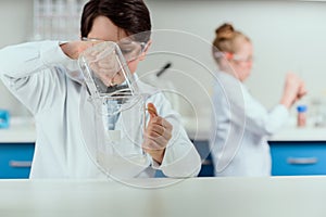 Schoolchildren with science lab equipment in chemical lab