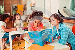 Schoolchildren solving math problems during the lesson