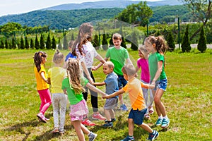 Schoolchildren with teacher have dance and sing lesson