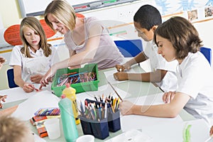 Schoolchildren and their teacher in an art class