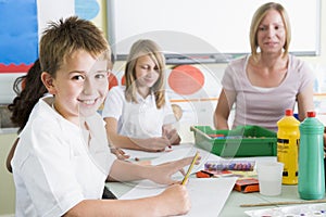 Schoolchildren and their teacher in an art class