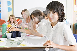 Schoolchildren and their teacher in an art class