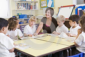 Schoolchildren and their teacher in class photo