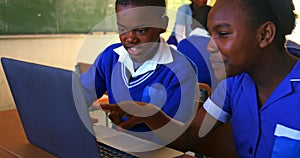 Schoolchildren using laptop in a lesson at a township school 4k