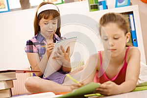 Schoolchildren writing into booklet