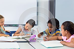 Schoolchildren writing on books