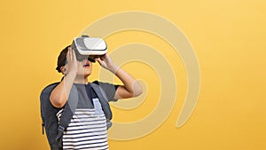 Schooler boy with backpack using VR glasses, copy space