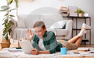 Schooler having videochat on digital tablet from home