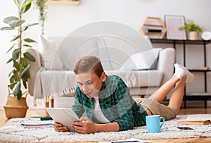 Schooler using digital tablet while studying at home