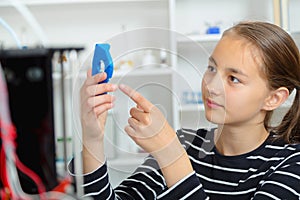 Schoolgirl with 3d printe. education, technology.