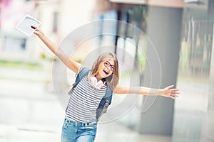 Schoolgirl with bag, backpack. Portrait of modern happy teen sch