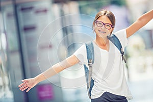 Schoolgirl with bag, backpack. Portrait of modern happy teen school girl with bag backpack. Girl with dental braces and glasses