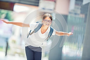 Schoolgirl with bag, backpack. Portrait of modern happy teen school girl with bag backpack. Girl with dental braces and glasses