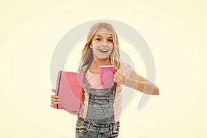 Schoolgirl with book or notepad and mug having tea break. Water balance concept. Enjoying tea before school classes