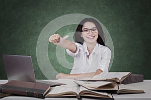 Schoolgirl with books and OK sign