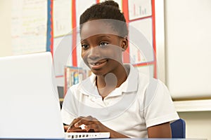 Schoolgirl In IT Class Using Computer