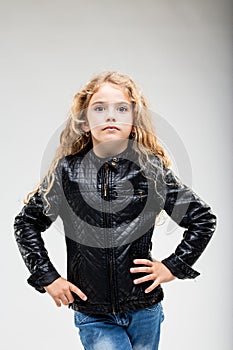 Schoolgirl with curly hair wearing leather jacket