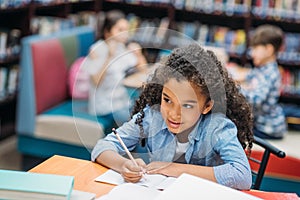 african american schoolgirl doing homework