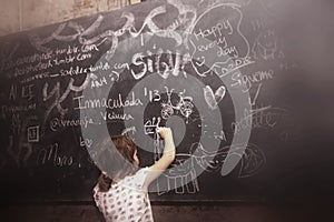 Schoolgirl drawing on a blackboard