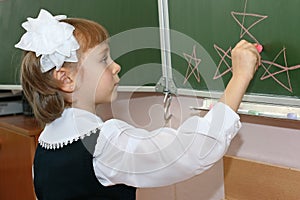 The schoolgirl draws on a school board