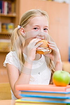 Schoolgirl eating fast food