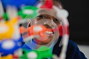 Schoolgirl experimenting molecule model against black background