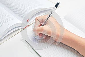 schoolgirl is going to write in a notebook. homework solution