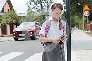 Schoolgirl with headphones and tablet